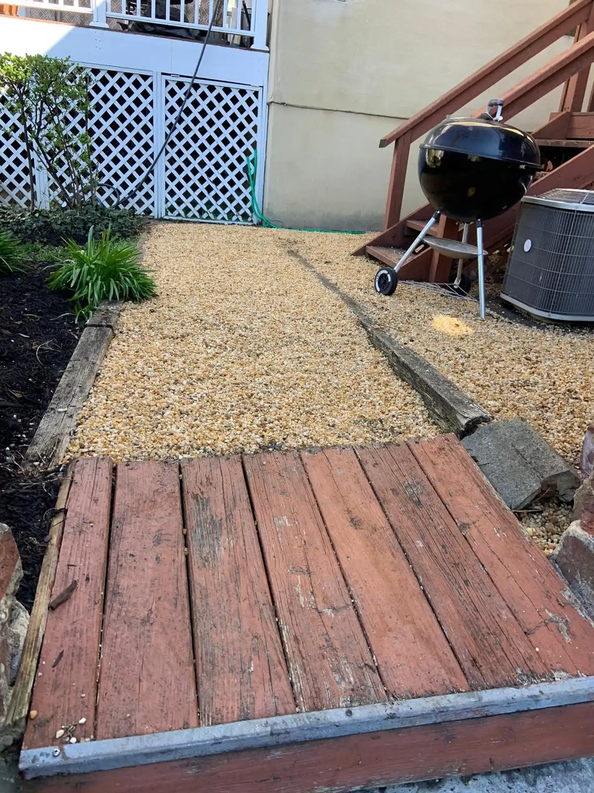 Gravel patio adjoining a wood deck